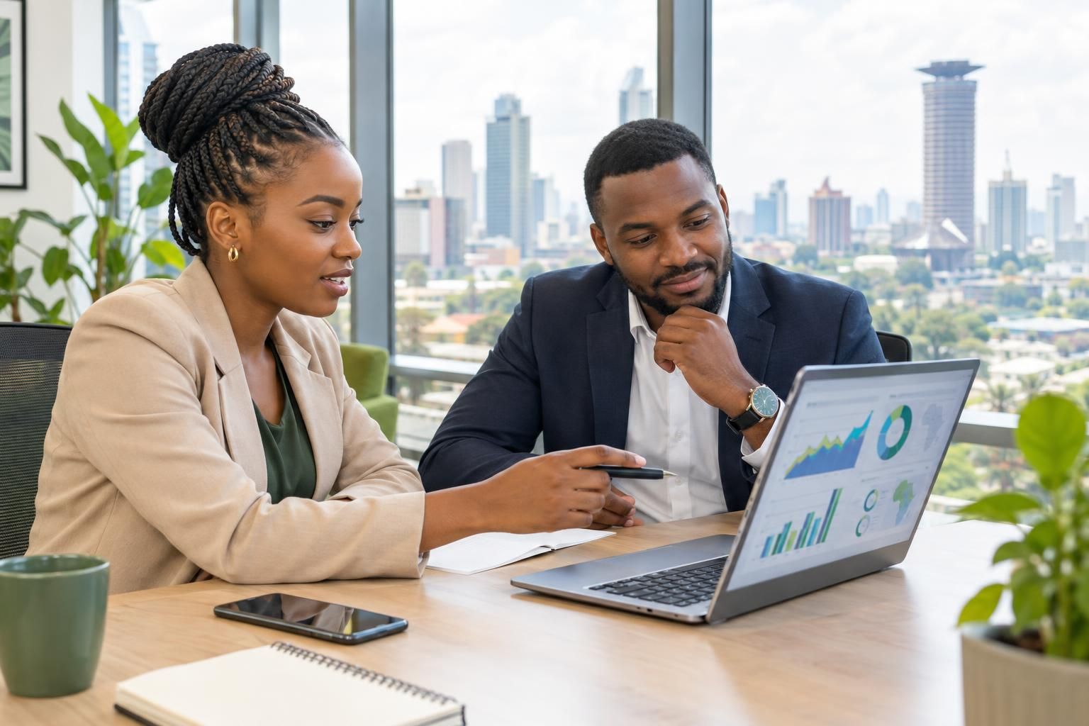 Kenyan business professionals comparing SEO services in Nairobi on a laptop