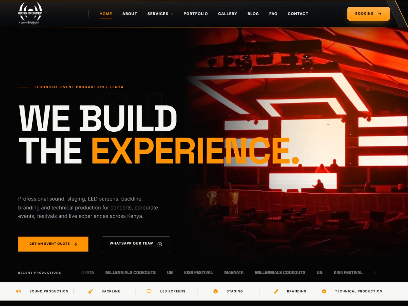Waveform Entertainment homepage: We build the experience headline over a red-lit stage, with quote and WhatsApp buttons